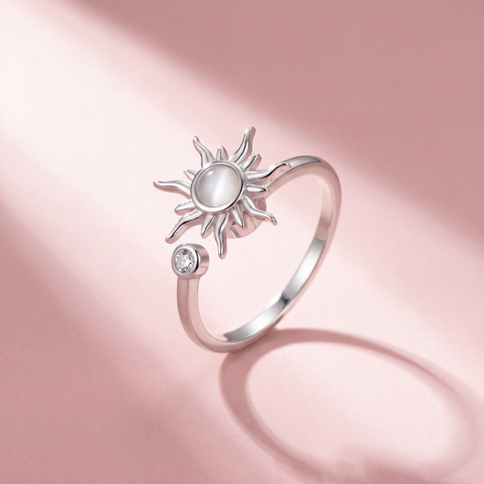 Fidget Sun Flower Ring Silber mit milchig weißem Stein auf rosa Hintergrund